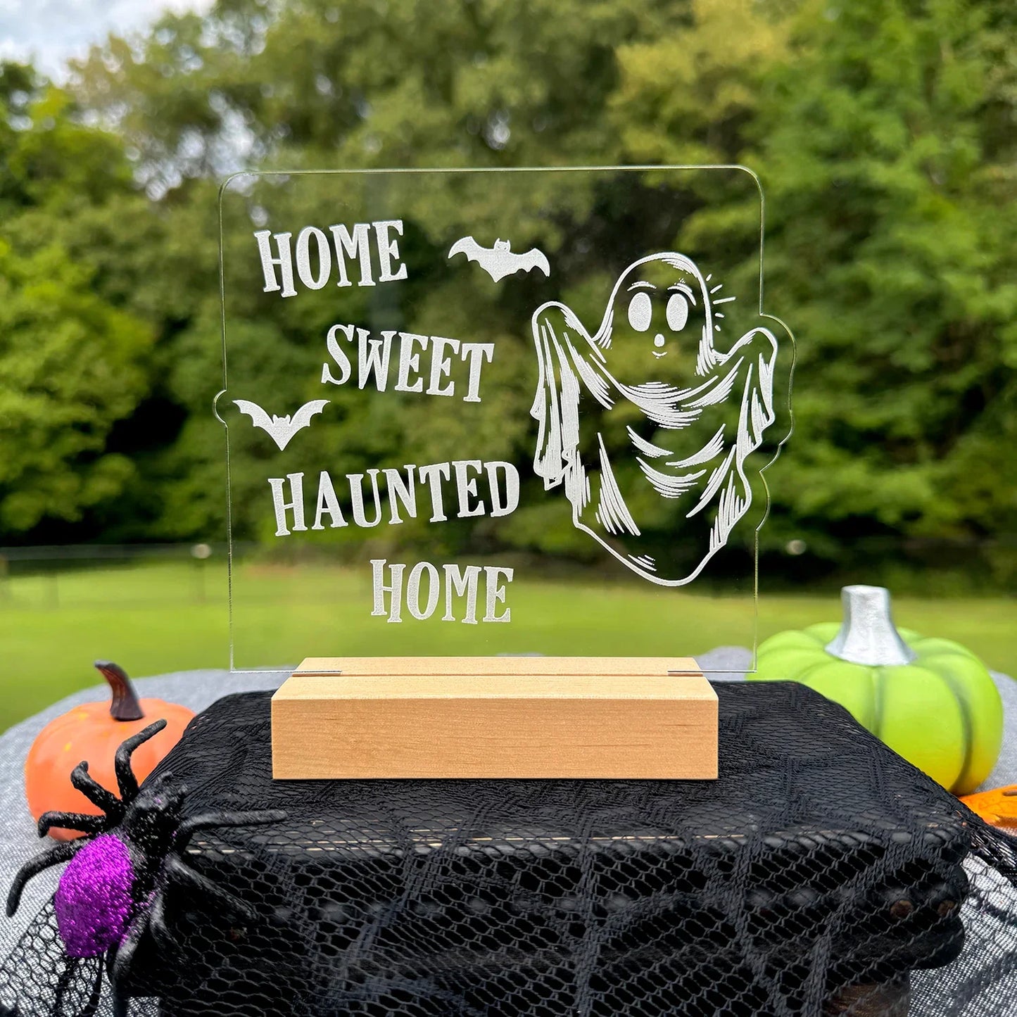 Home Sweet Haunted Home Halloween LED nightlight with acrylic ghost design in outdoor setting.