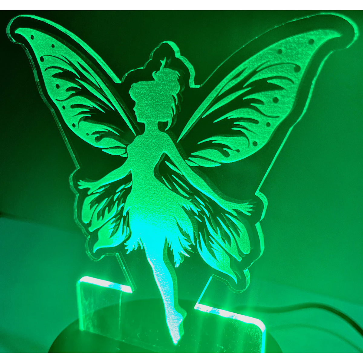 Fairy LED Nightlight #4 glowing in green light, shaped like a fairy with detailed wings.