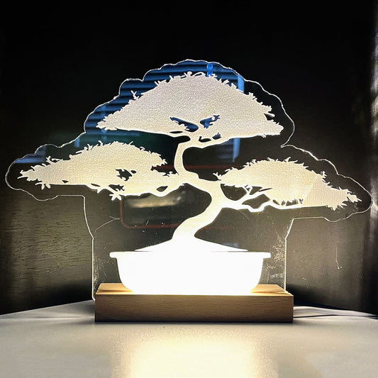 Large bonsai LED nightlight with wooden base illuminating a room.