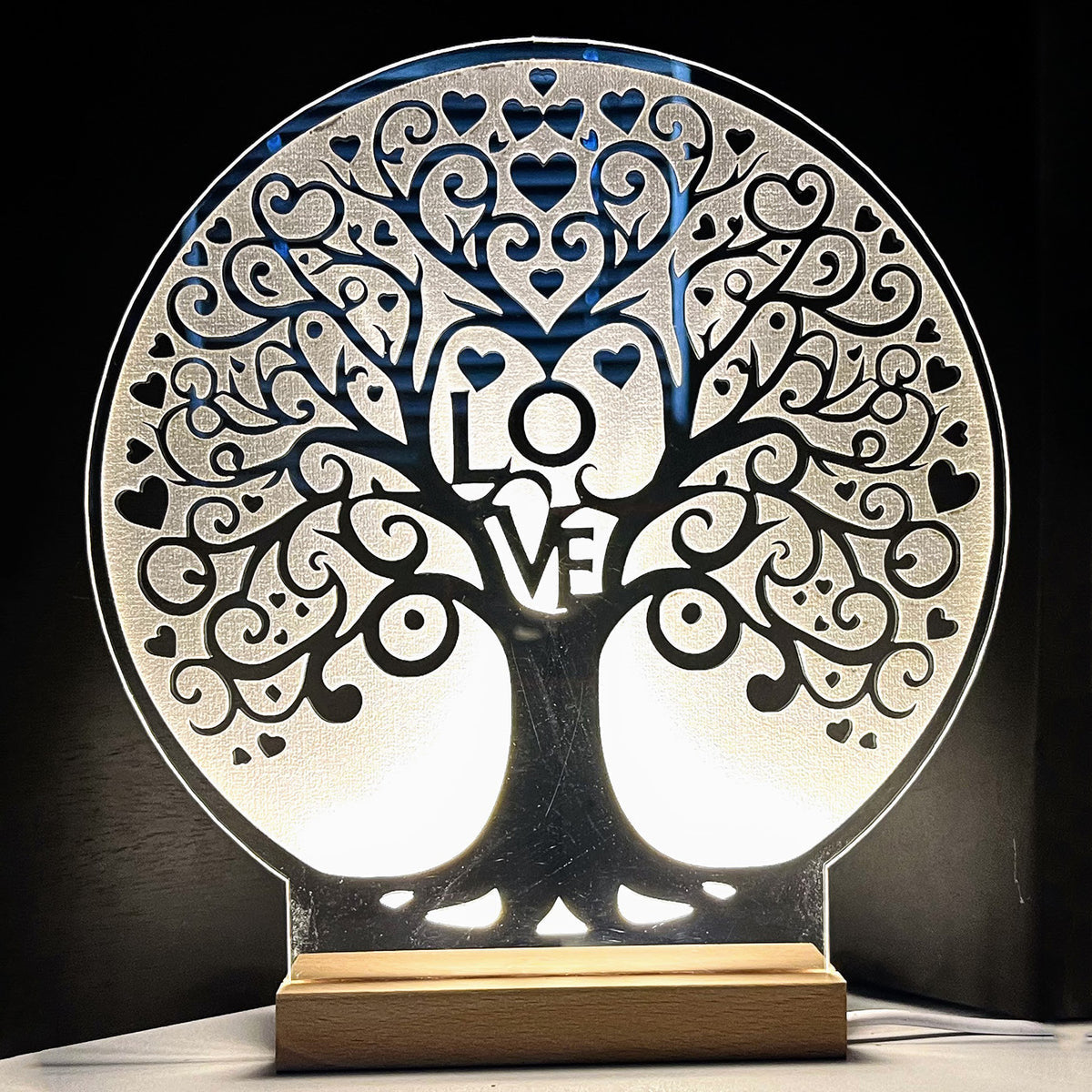 Tree of Life large LED nightlight with intricate love design illuminates a room.