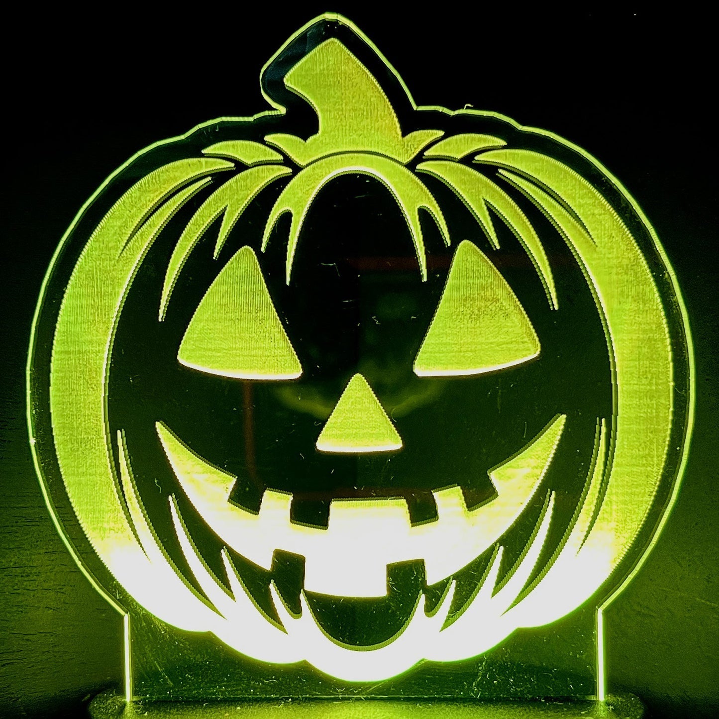 Smiling Jack-O-Lantern LED nightlight glowing in the dark.