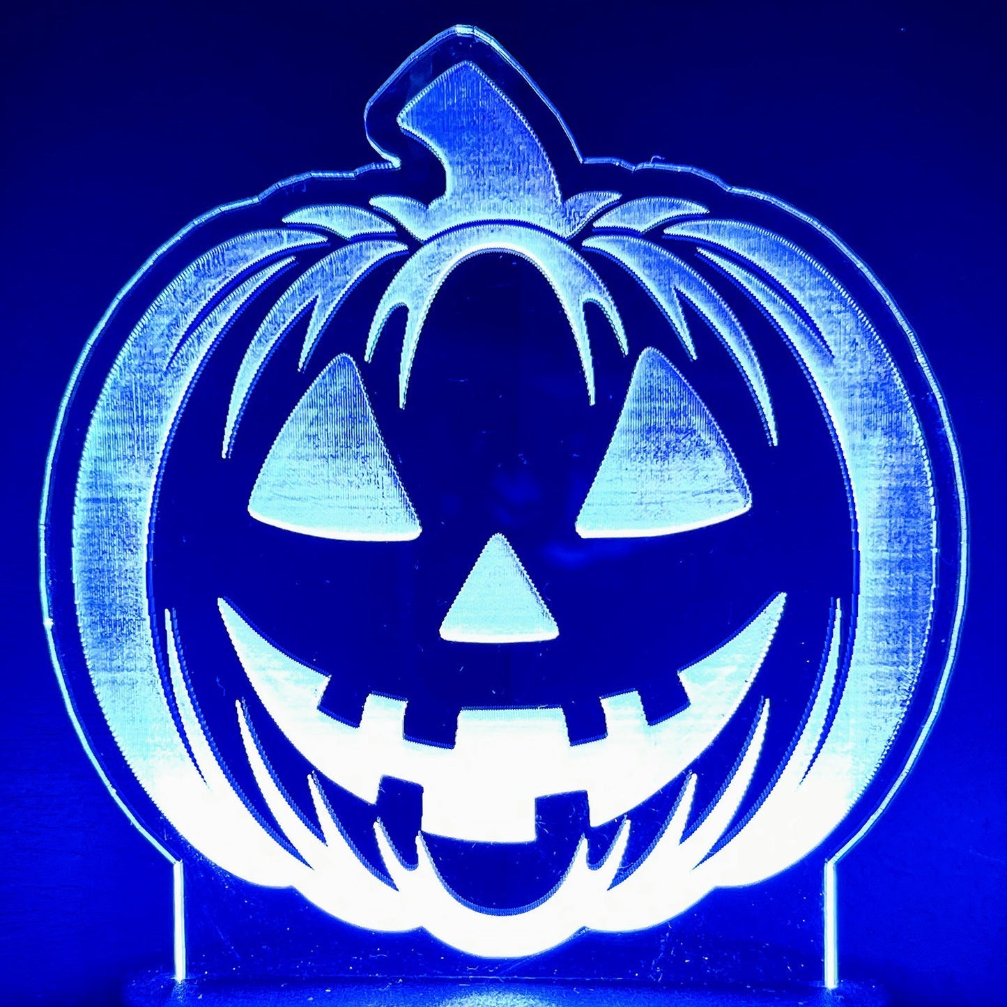 Smiling Jack-O-Lantern LED nightlight glowing in the dark.